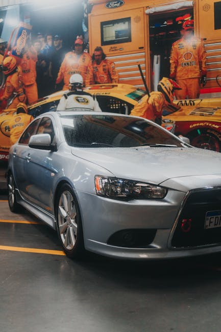 Luxury Cars - A modern silver car parked in a dynamic garage w #10182855