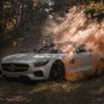 Luxury Cars - A luxury white Mercedes Benz parked in a misty f #10215508