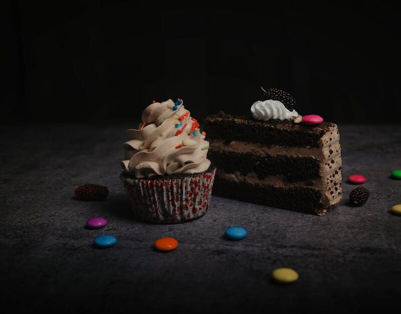 Food Aesthetics - Close-up of a chocolate cake slice and cupcake w #11774178