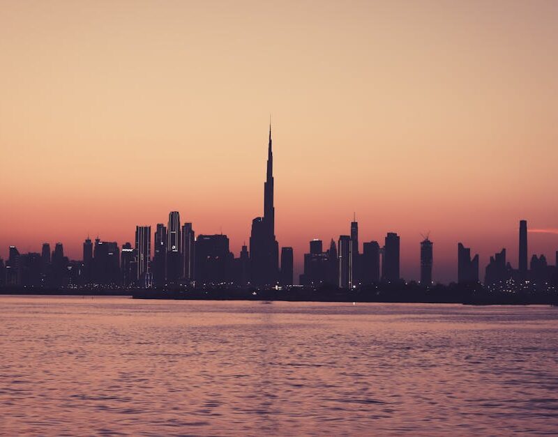 City Architecture - Scenic view of Dubai skyline at sunset featuring #15533154