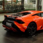 Luxury Cars - Rear view of an orange sports car in an upscale #17632111