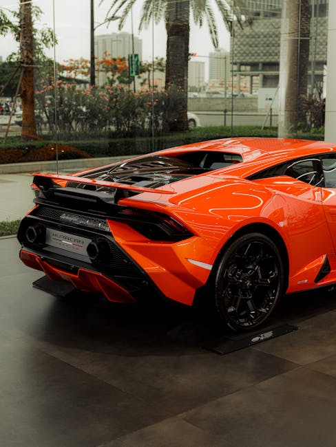 Luxury Cars - Rear view of an orange sports car in an upscale #17632111