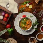 Food Aesthetics - A vibrant Indian meal surrounded by spices and f #19834447