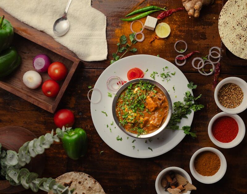 Food Aesthetics - A vibrant Indian meal surrounded by spices and f #19834447