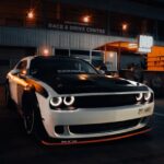 Luxury Cars - A sleek Dodge Challenger sports car parked at a #20863357
