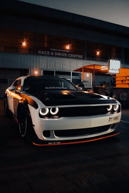 Luxury Cars - A sleek Dodge Challenger sports car parked at a #20863357
