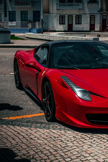 Luxury Cars - A vibrant red sports car parked on an urban stre #27530033