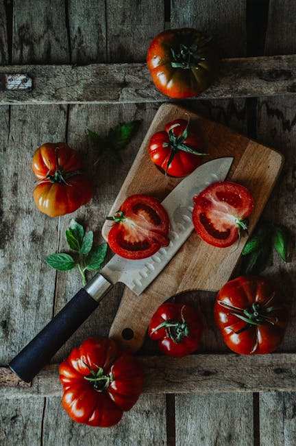 Food Aesthetics - Fresh heirloom tomatoes and knife on rustic wood #29081092