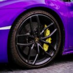 Luxury Cars - Detailed view of purple luxury sports car wheel #32364025