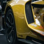 Luxury Cars - Detailed view of a yellow sports car featuring s #34214697