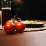 Food Aesthetics - Close-up of ripe tomatoes with a glass of juice #34520966