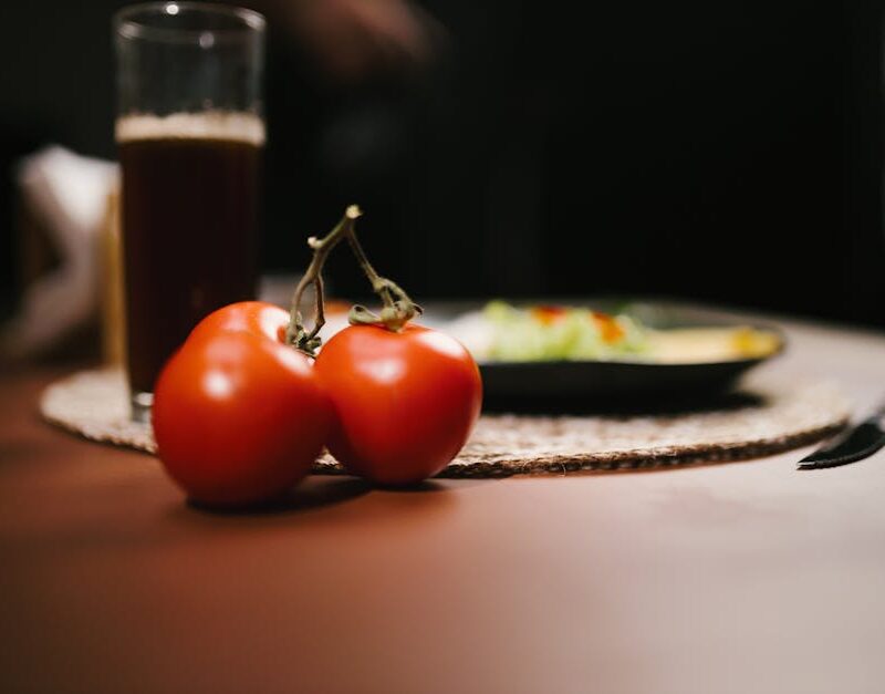Food Aesthetics - Close-up of ripe tomatoes with a glass of juice #34520966