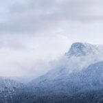 Mountain Landscapes - Serene winter view of a misty, snow-covered moun #35039349