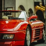 Luxury Cars - Sleek red Ferrari parked on city street, epitomi #35189512