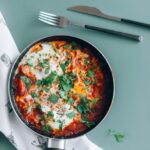 Food Aesthetics - Delicious shakshuka in a pan garnished with fres #6275160