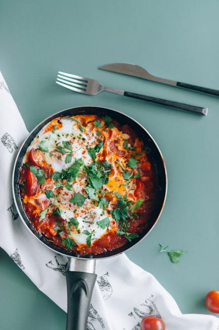 Food Aesthetics - Delicious shakshuka in a pan garnished with fres #6275160