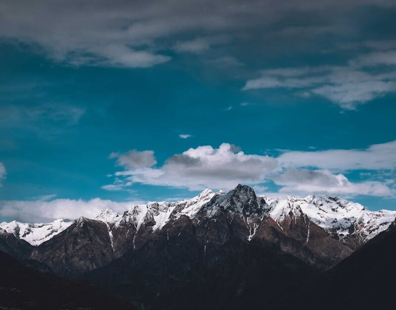 Mountain Landscapes - Picturesque view of high mountain peaks covered #7844512